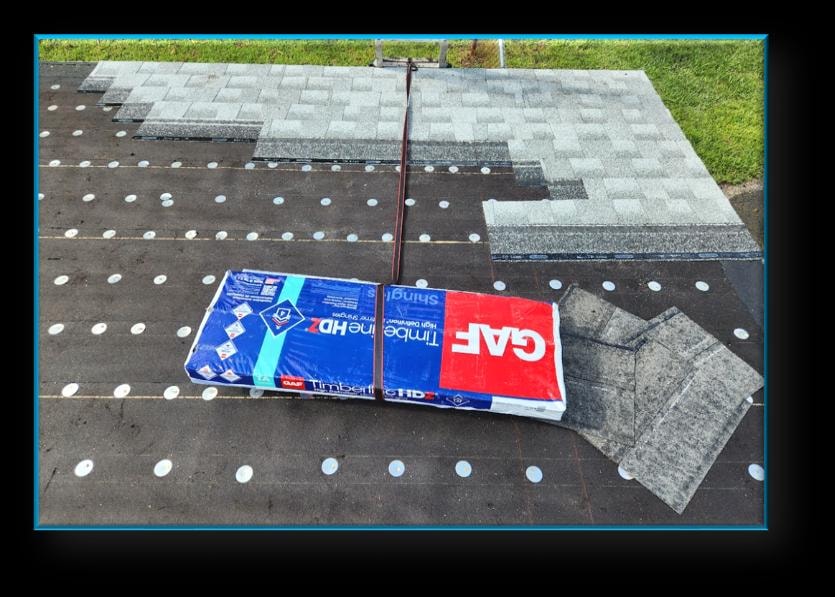GAF Timberline HDZ shingles staged on roof deck during installation – Artisan Roof Specialists