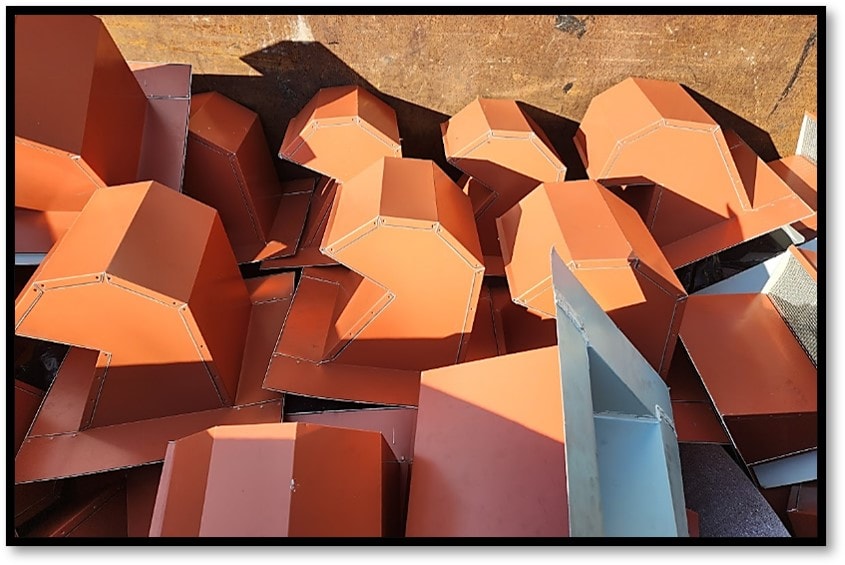 Copper-tone metal hip caps staged for installation – Job 22-071-F