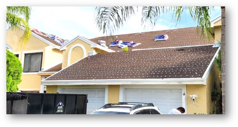 Condo townhome shingle installation in progress with materials staged on roof – Job 23-010