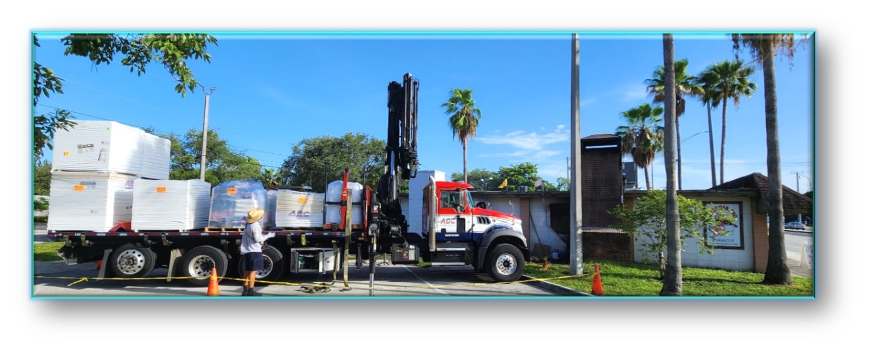 ABC Supply crane truck delivering roofing materials to commercial job site – Job 26-016