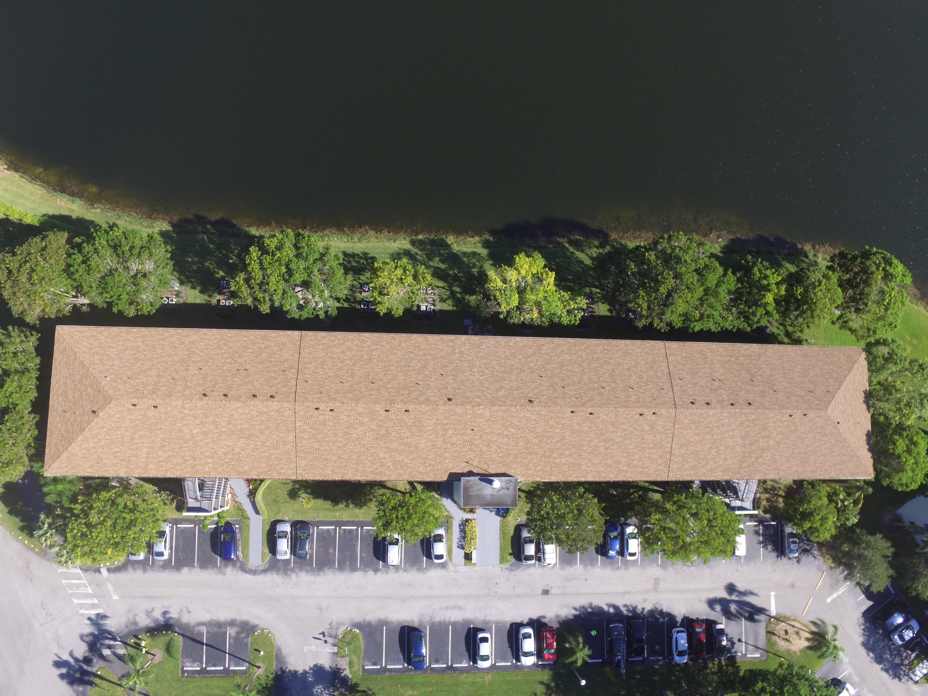 Aerial view of Century Village Ivanhoe building with completed shingle roof replacement – waterfront property