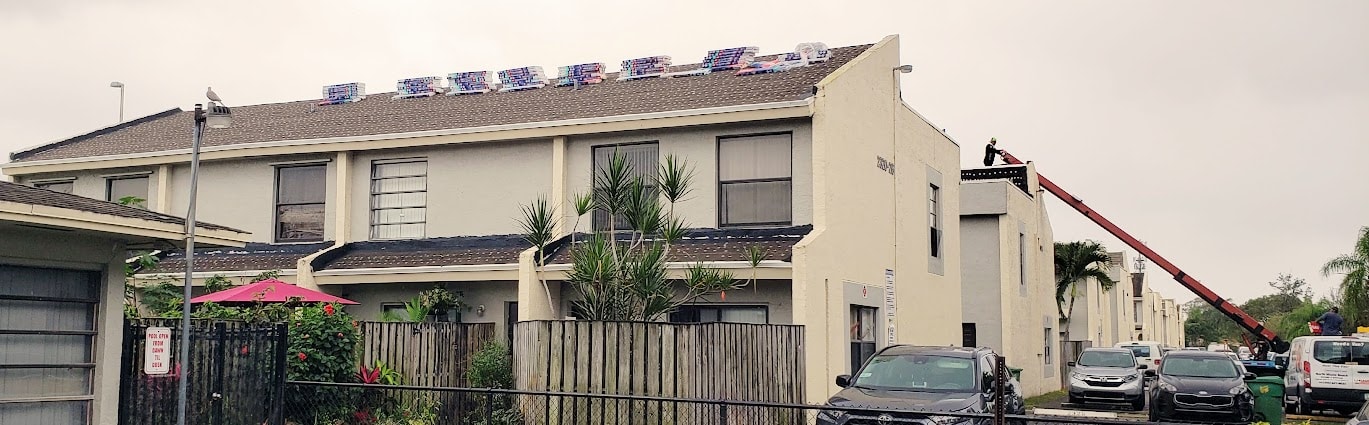 Condo building with exposed roof deck and trusses during full tear-off – Century Gardens, Lauderhill, FL