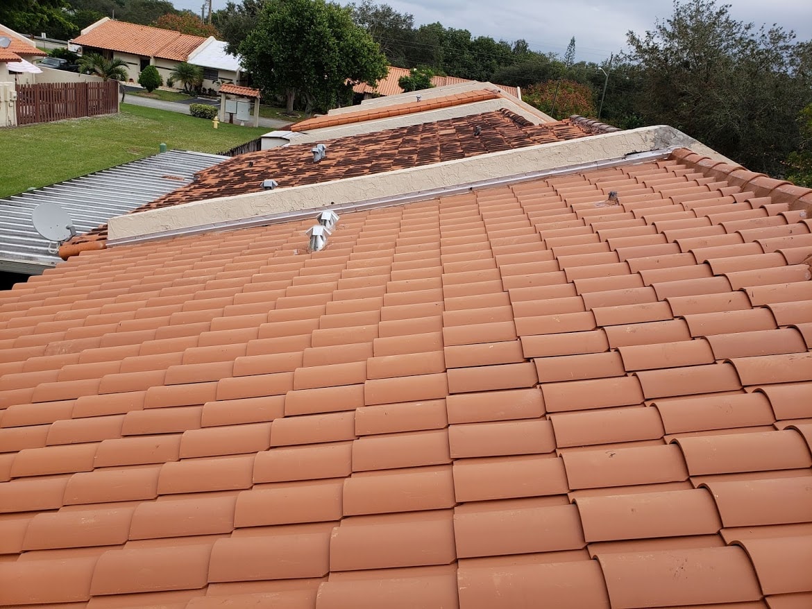 Close-up of completed terracotta clay tile roof installation with pipe boots – Villa Roof Replacement