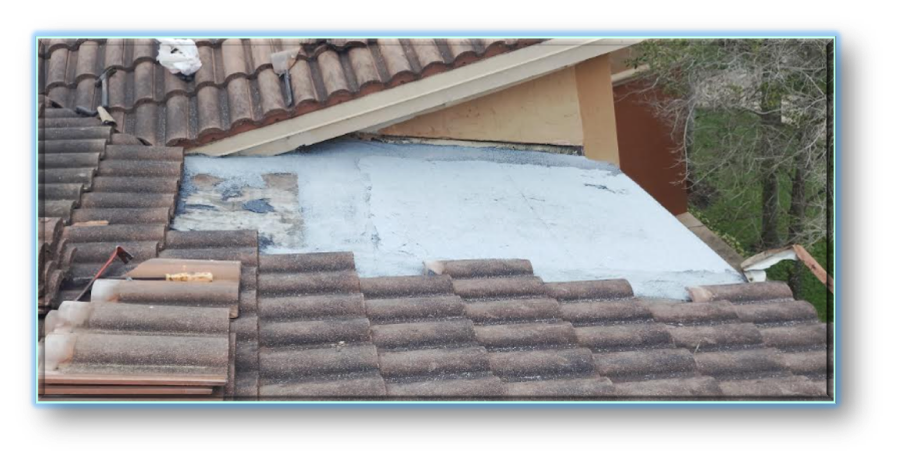Completed flat roof section with white membrane fully applied next to restored clay barrel tile field – Job 26-132