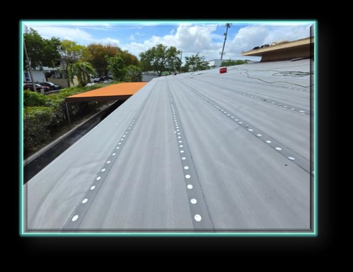 Concrete tile roof base sheet installation with fastener rows and orange accent structure – Artisan Roof Specialists