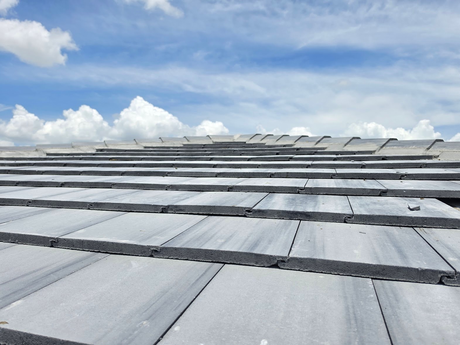 Close-up of concrete tile rows against blue sky – Job 25-127