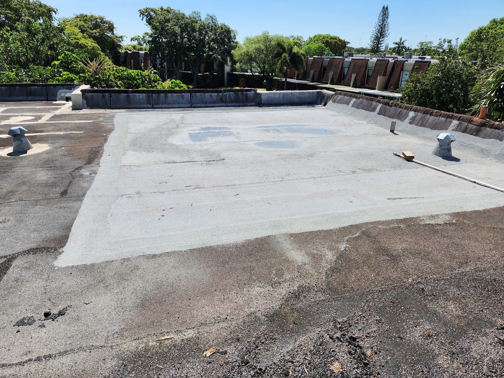 Completed flat roof repair with new cap sheet membrane
